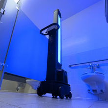 Load image into Gallery viewer, Advanced UV light robot, OhmniClean, autonomously disinfecting equipment and surfaces in a medical facility, showcasing UV robotics technology.